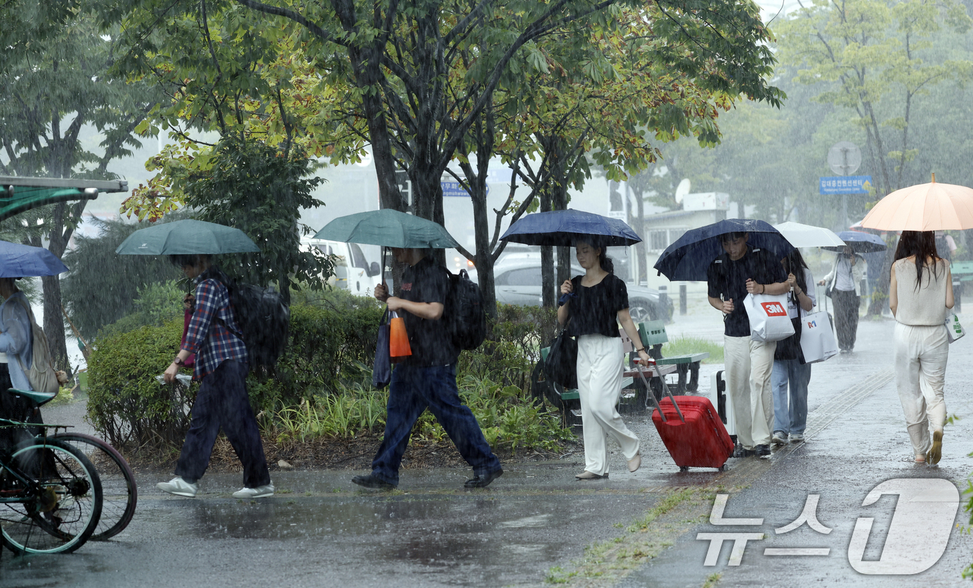 (광주=뉴스1) 김태성 기자 =  28일 전남광주통합특별시 서구 김대중컨벤션센터 앞에서 시민들이 우산으로 비를 피하며 발걸음을 재촉하고 있다. 2026.8.28/뉴스1