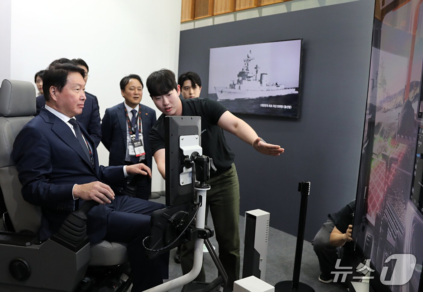 본문 이미지 -  최태원 SK그룹 회장이 11일 울산시 울주군 울산전시컨벤션센터(UECO)에서 ‘2026 울산포럼’과 연계해 열린 ‘WAVE 2026(울산세계미래산업박람회)’ 전시장을 찾았다. 최 회장이 HD현대 부스에서 VR 시뮬레이션을 체험하는 모습. (사진제공=SK이노베이션)