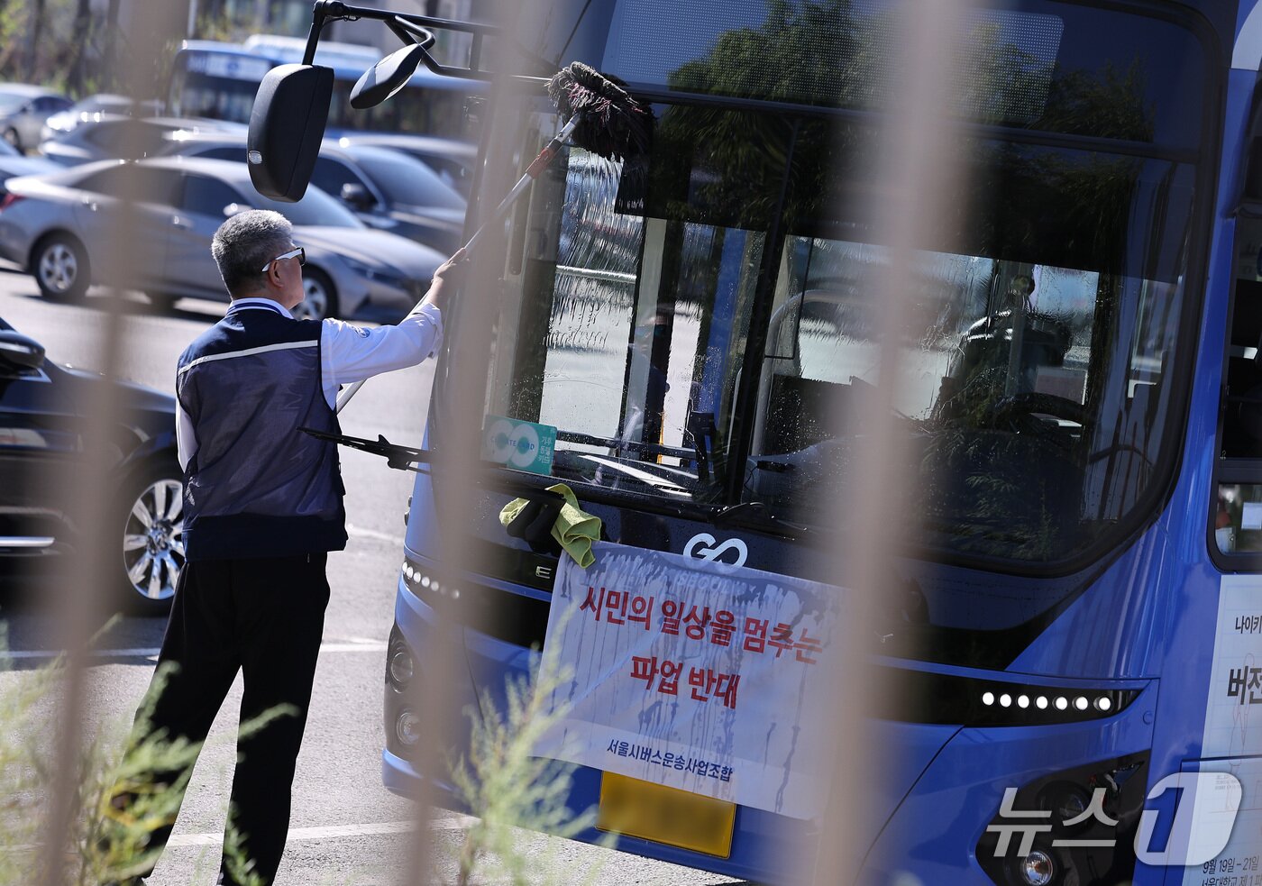 본문 이미지 - 서울 시내버스 노조의 파업 예고일을 하루 앞둔 15일 서울 시내 한 공영차고지에서 한 버스 기사가 세차를 하고 있다. 2026.9.15 ⓒ 뉴스1 김성진 기자