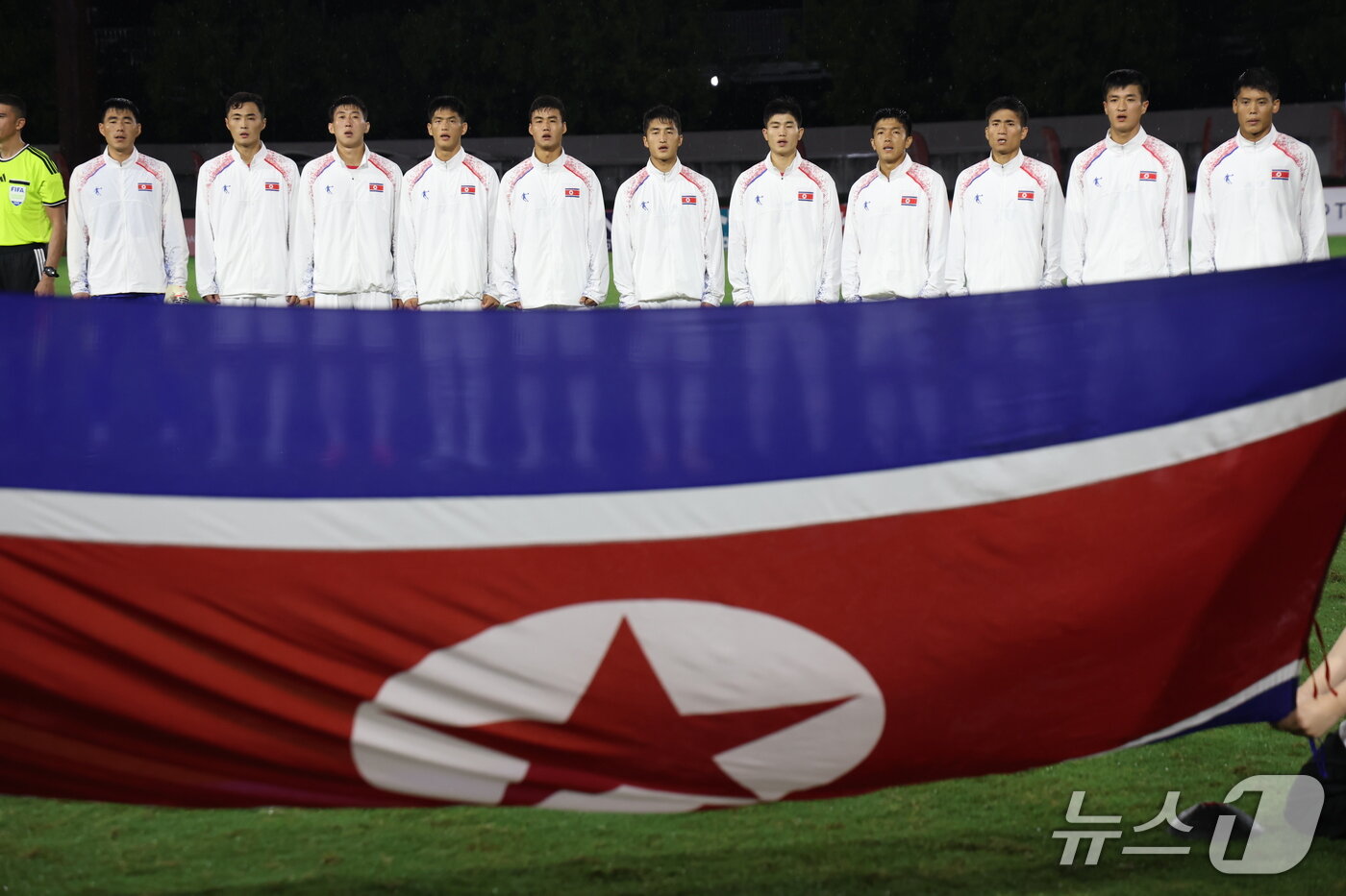 본문 이미지 - 북한 축구대표팀 선수들이 16일 오후 일본 아이치현 가리야 웨이브 스타디움에서 열린 2026 아이치·나고야 아시안게임 남자축구 B조 1차전 중국과의 경기를 앞두고 국기에 대한 경례를 하고 있다. 2026.9.16 ⓒ 뉴스1 김민지 기자