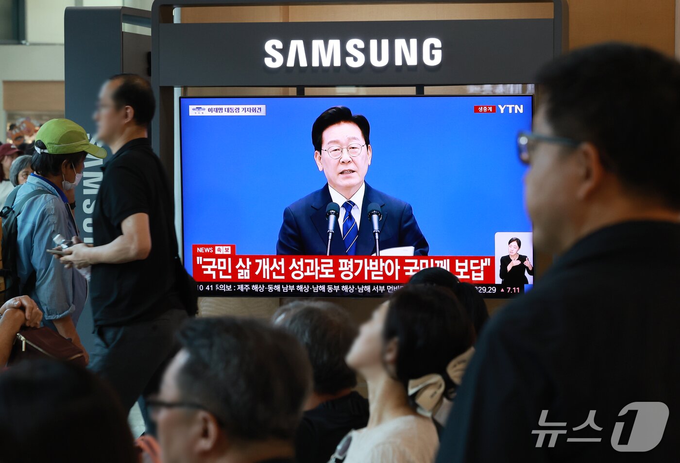 본문 이미지 - 18일 오전 서울 중구 서울역 대합실에서 시민들이 이재명 대통령의 기자회견 생중계를 지켜보고 있다. 2026.9.18 ⓒ 뉴스1 이호윤 기자