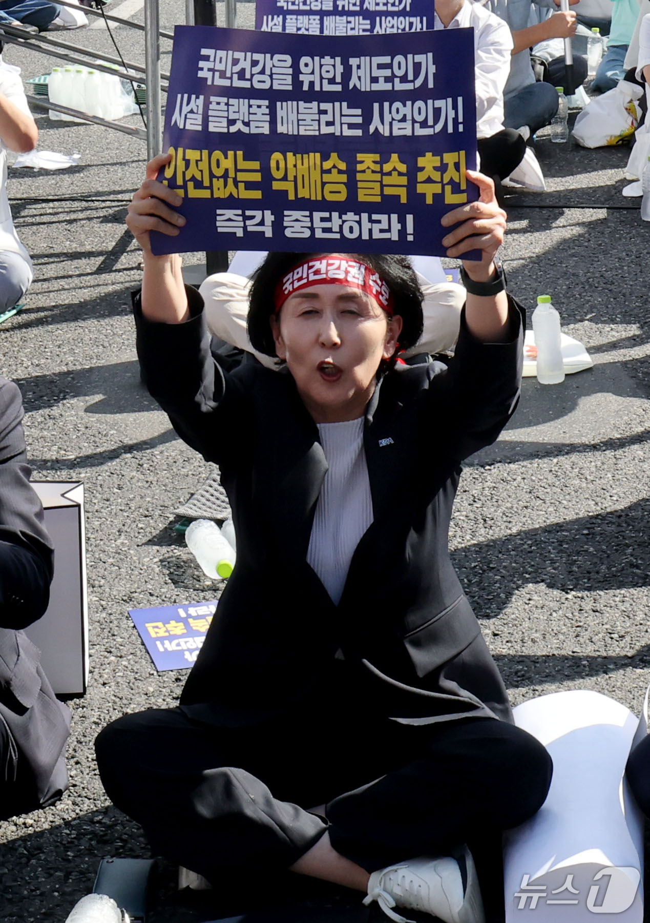 (서울=뉴스1) 이광호 기자 = 권영희 대한약사회장이 20일 오후 서울 종로구 광화문 동화면세점 앞에서 열린 '국민건강·건강보험 수호 전국약사 총궐기대회'에서 손피켓을 들고 비대면 …