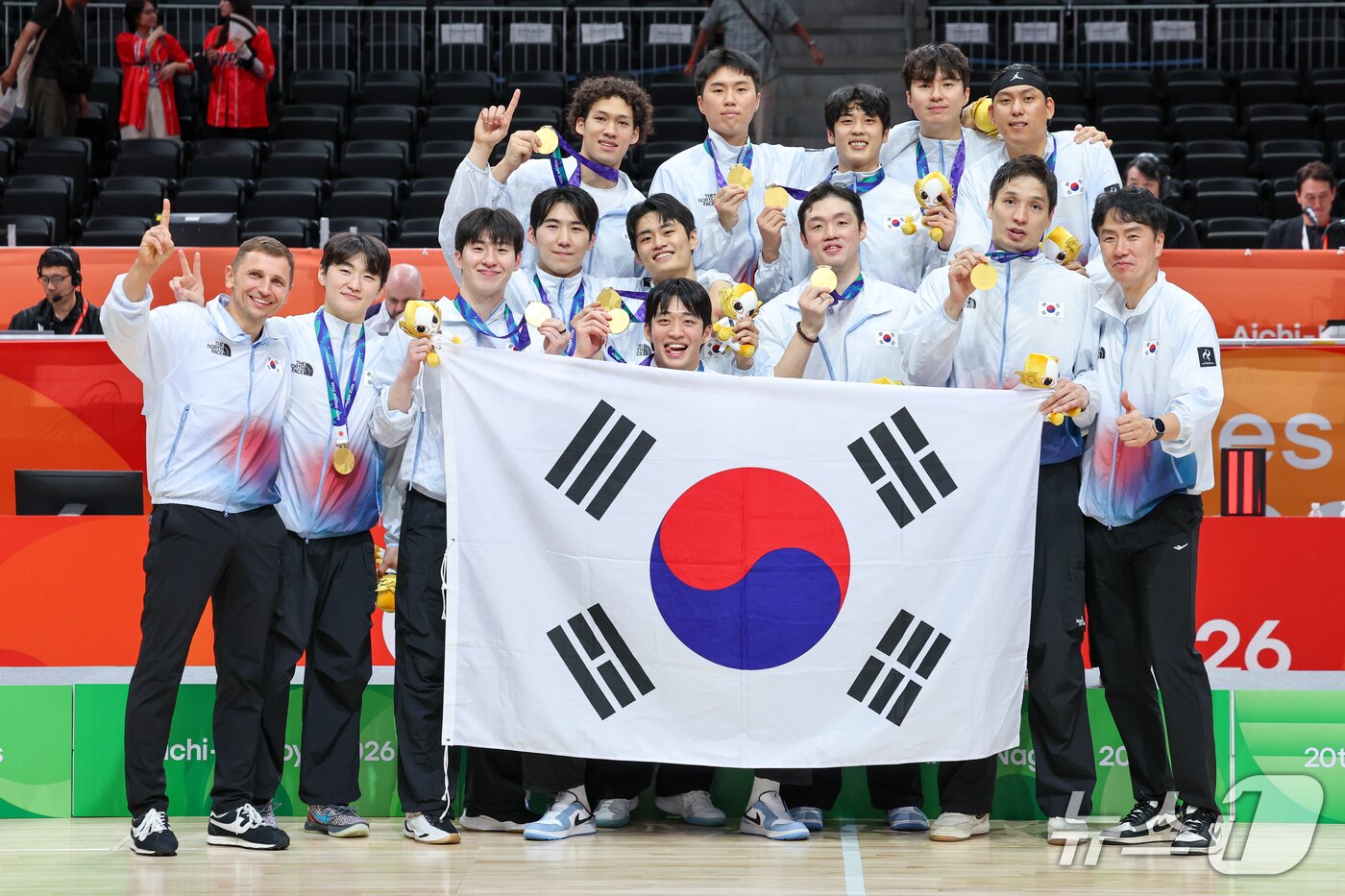본문 이미지 - 20일 일본 나고야 아이치 인터내셔널 아레나에서 열린 2026 아이치·나고야 아시안게임 남자농구 결승전 시상식에서 12년 만에 금메달을 획득한 대한민국 선수들이 마줄스 감독과 함께 태극기를 들고 기념 촬영을 하고 있다. 2026.9.20 ⓒ 뉴스1 안은나 기자