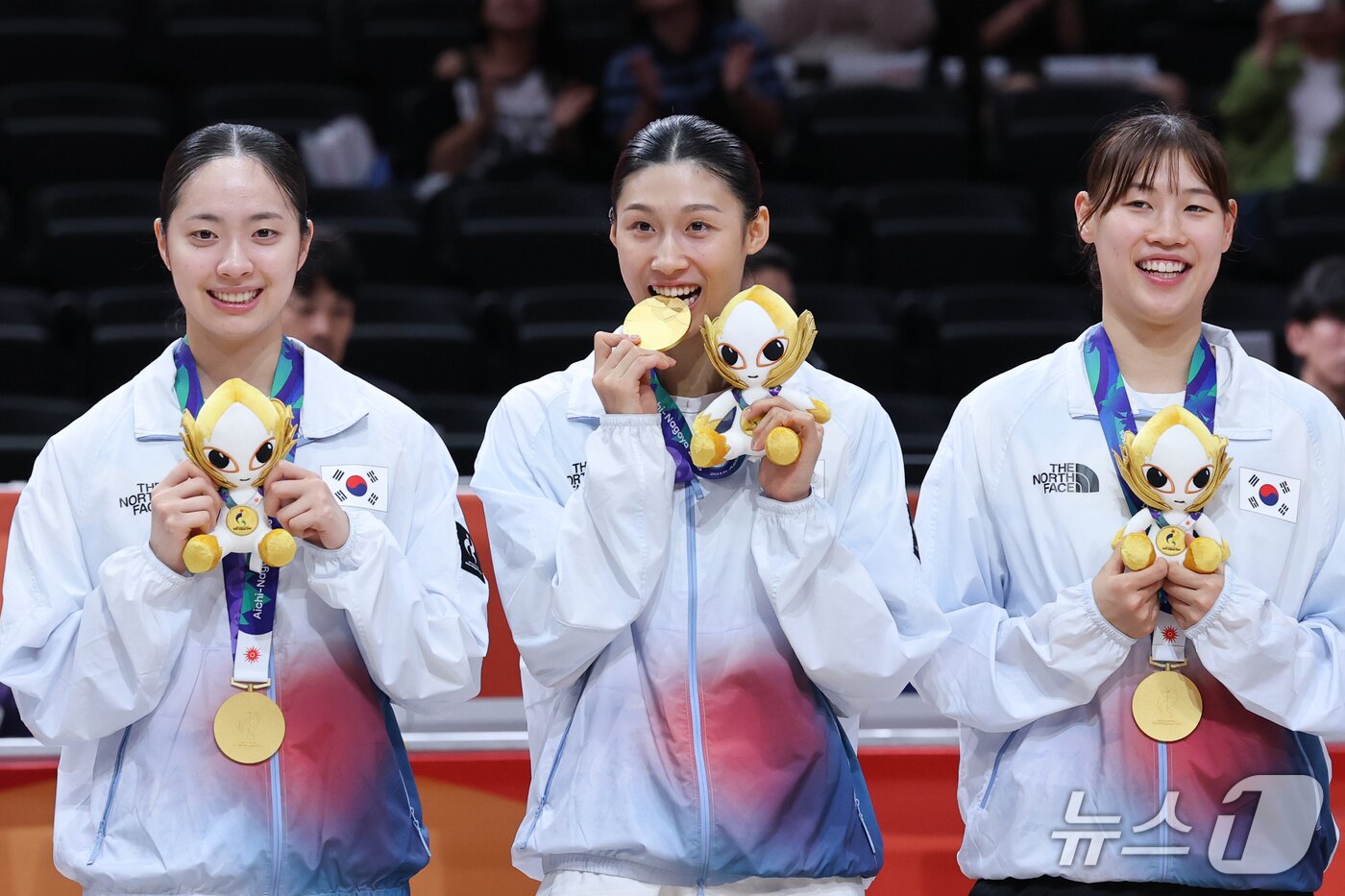 본문 이미지 - 대한민국 이해란(가운데)이 26일 일본 나고야 아이치 인터내셔널 아레나에서 열린 2026 아이치·나고야 아시안게임 여자농구 시상식에서 금메달을 깨물고 있다. 2026.9.26 ⓒ 뉴스1 안은나 기자