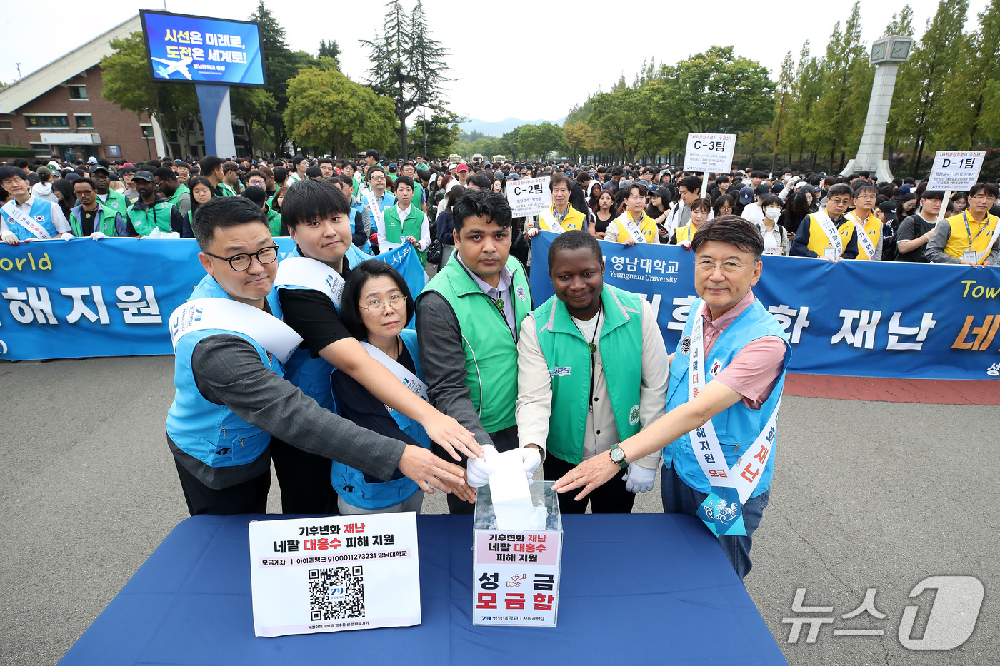 (경산=뉴스1) 공정식 기자 = 28일 최외출 영남대 총장(오른쪽)을 비롯해 학생, 유학생, 교수, 직원 등 대학 구성원들이 '네팔 대홍수 피해 지원 성금 모금'에 동참하고 있다. …